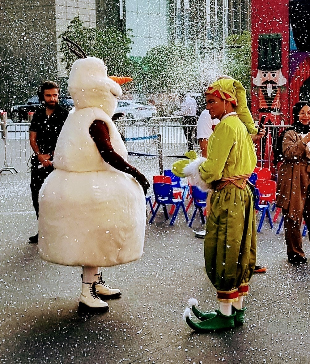 Person with mascot characters backstage