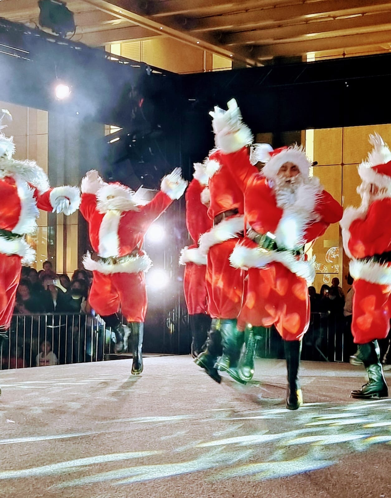 Festive costumed characters with children in snow